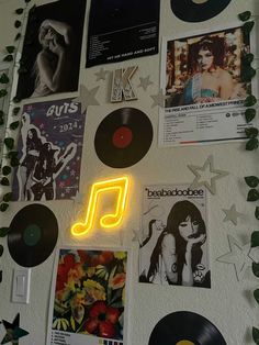 a wall with various records and neon lights