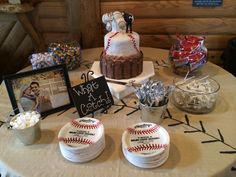 a table topped with cakes and candies covered in baseball themed icing next to pictures