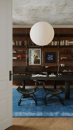 a table and chairs in a room with bookshelves