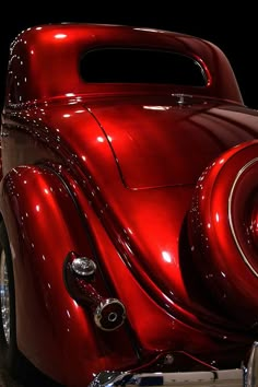 the front end of an antique red car