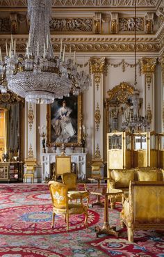 an ornately decorated room with chandeliers and chairs