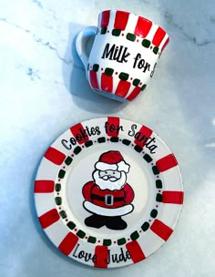 two plates with santa claus designs on them, one has a coffee cup and saucer