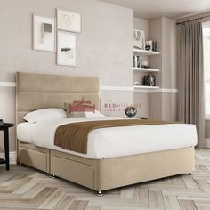 a large bed sitting on top of a hard wood floor next to a wall mounted book shelf