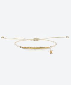 two bracelets with gold beads and charms on white string, one is adjustable to the wrist