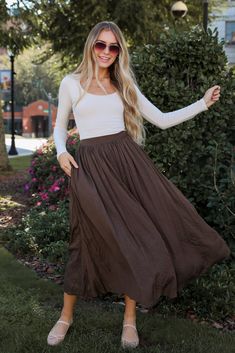 You'll be radiating the most gorgeous energy in the Truly Profound Brown Maxi Skirt! Made from a soft, lightweight fabric, this maxi skirt features a flattering, relaxed fit that cascades elegantly to the floor. The rich brown hue offers a warm, earthy tone, making it easy to pair with a variety of tops, from casual tees to dressy blouses. With a comfortable elastic waistband, this skirt ensures a perfect fit while allowing for ease of movement. Whether you’re heading to the beach, running erran Boho Maxi Skirt Outfit, Brown Maxi Skirt, Dressy Blouses, Brown Maxi Skirts, Beach Running, Maxi Skirt Outfits, Casual Tees, Maxi Skirt Boho, Dressy Blouse