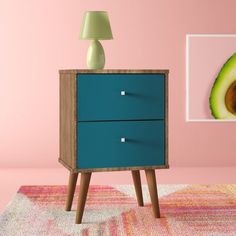 an avocado sitting on top of a blue dresser next to a pink wall