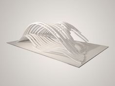 a white sculpture with wavy lines on it's sides and an upside down section in the middle