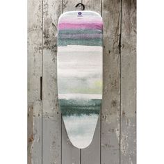 a surfboard hanging on the side of a wooden wall