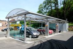 a parking lot with several cars parked in it and one has a canopy over the car