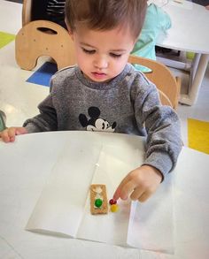 a little boy that is sitting at a table