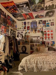 a bedroom with posters on the wall and bed in it's centerpieces