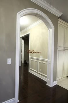 an empty room with hard wood floors and white trim