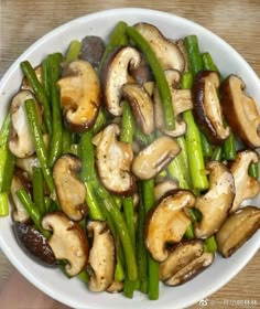 a white bowl filled with mushrooms and green beans