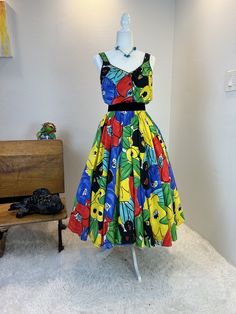 1980s dress / 80s dress / vintage 1980s dress / 1980s does 1950s dress / 1980s dress / vintage 1950s style dress / vintage sundress This 1980s sundress is amazing. First let me start by saying this is one of those simple dresses that has so much style. She is a sundress with a button front and a comfortable elastic waist band. But what I really love is her vibrant print and the full skirt with hidden pockets! Classic sundress cut, but with a gorgeous bold colors means you will never see anyone else in this dress! Truly a timeless dress made for fun!  Measurements provided are flat and have been doubled. Bust 36"  Waist 26-28" range (small) Hips free Length  48" ❤️ Condition: Excellent vintage condition. Flaw: none found. Belt in photos not included. This item has been cleaned and is ready Retro Summer Dresses Lined, Vintage Style Summer Midi Dresses, Retro Lined Summer Dresses, Vintage Style Midi Length Summer Dresses, Retro Vintage Midi Length Dress For Garden Party, Summer Vintage Fashion A-line Midi Dress, Summer A-line Midi Dress For Vintage Fashion, Vintage Sleeveless Midi Dress For Garden Party, Summer Vintage A-line Midi Dress