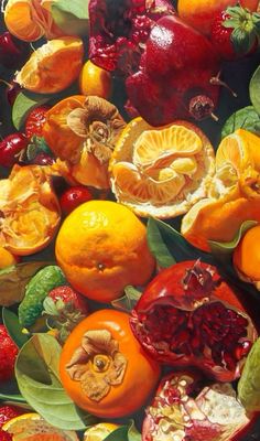 an arrangement of fruit including oranges, cranberries and pomegranates