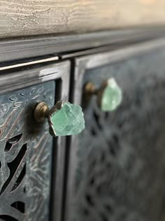 an ornate wooden cabinet with green glass knobs