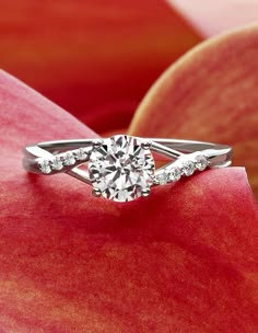 a diamond ring on top of an apple