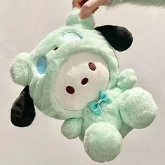 a person holding a stuffed animal in the air