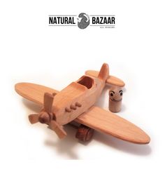 a wooden toy airplane sitting on top of a table