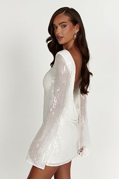 We recommend sizing down in this style. It might be love. The NALA Sequin Mini Dress was designed to be the perfect second-dress for dance-floor-loving brides. It has been crafted from our custom sequinned and beaded fabrication that shines bright in the light. The back features a low cowl to give it extra drama. Wear with our Caitlin Diamante Rope Heels to complete the look. FEATURES: High neckline Low cowl back Lined body Mini length FIT, FABRIC & CARE: Natalie is 173cm/5'8 and wears a size S; Disco White Outfit, New Years Eve Dress Classy, Dress For Bachelorette Party, Cowl Back Wedding Dress, Wedding Fits, Sparkling Dress, Second Dress, Be Love, Sparkly Dress