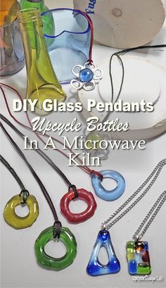 some glass pendants are sitting on a table with the words diy glass pendants