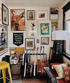 a room filled with guitars and pictures on the wall