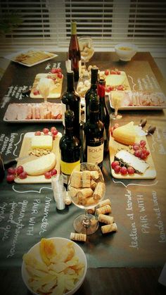 a table topped with plates and bottles of wine