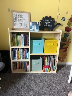 a child's room with bookshelf and toys on the carpeted floor