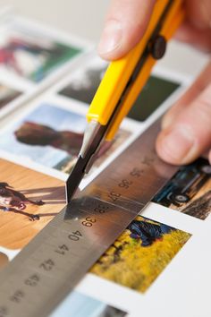 a person holding a pencil and measuring pictures