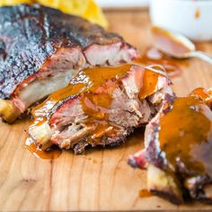 ribs covered in bbq sauce on a cutting board