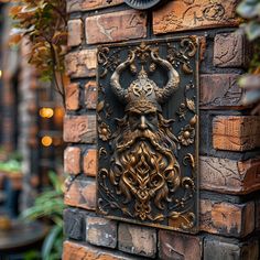 an intricately designed plaque on the side of a brick wall with a horned head