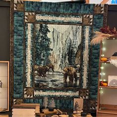 a quilted wall hanging with bears in the woods on it's front and back