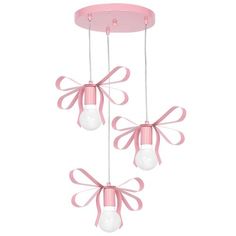 three light fixtures with pink bows on them and two bulbs hanging from the ceiling above