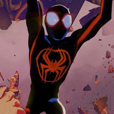 a man in a black and orange spider suit holding his hands up to the sky