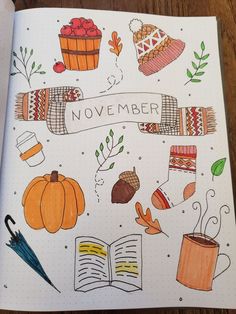 an open notebook with autumn doodles on the cover and writing that says, november