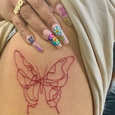 a woman with butterfly tattoos on her back and pink nail polish is holding onto the side of her thigh