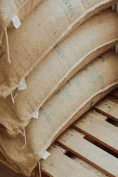 three pillows sitting on top of wooden pallets