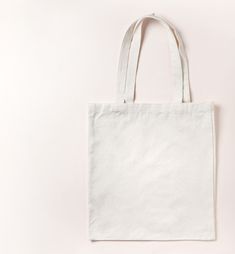 a white tote bag sitting on top of a table