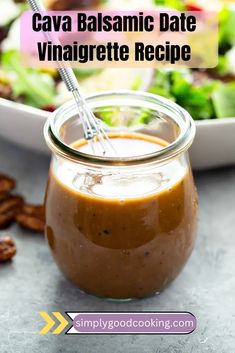 a glass jar filled with caramel sauce next to a plate of salad and nuts