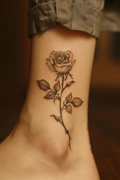 a small rose tattoo on the side of a woman's neck and lower leg