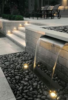 an image of a water fountain with lights on the ground and steps leading up to it