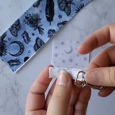 someone is holding something in their hand near a tie on the table with other items