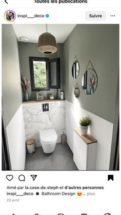 the bathroom is decorated in shades of gray and white, with an interesting mirror above the toilet