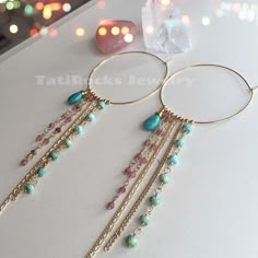 Gorgeous and versatile fringe hoop earrings with genuine Sleeping Beauty/ Arizona Turquoise and watermelon Tourmaline accents.  Perfect for day and night. Available in 14k gold filled, rose gold filled, and all sterling silver. 100% Waterproof Hoops measure 50mm. Turquoise stones are beautiful AAA quality stones. Bohemian Dangle Hoop Earrings With Natural Stones, Handmade Fusion Dangle Hoop Earrings, Bohemian Teardrop Earrings With Gemstone Accents, Bohemian Hoop Earrings With Dangling Charms, Coachella Earrings, Coachella Jewelry, Fringe Hoop Earrings, Sweet Surrender, Boho Hoop Earrings