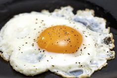 an egg is fried in a frying pan