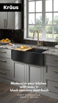 a kitchen with gray cabinets and black stainless steel sink