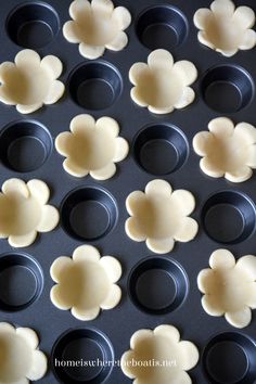 the pans are lined up and ready to be baked with flower shaped cookie cutters