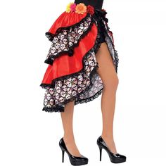 a woman wearing a red and black dress with skulls on it's skirt is posing for the camera