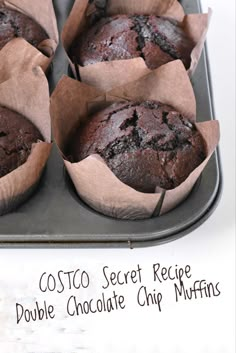 four chocolate muffins in paper cups on a tray with the words costa secret recipe double chocolate chip muffins