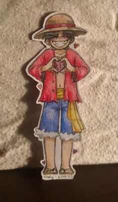 a drawing of a person wearing a hat and blue shorts with a red shirt on